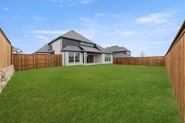 a view of a house with a backyard and a porch
