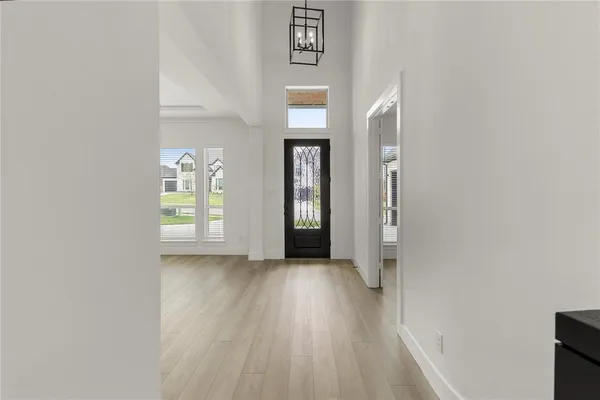 an empty room with wooden floor and a window