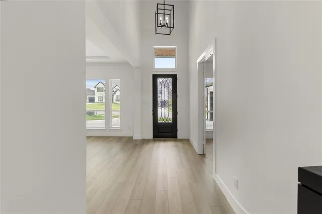 an empty room with wooden floor and a window