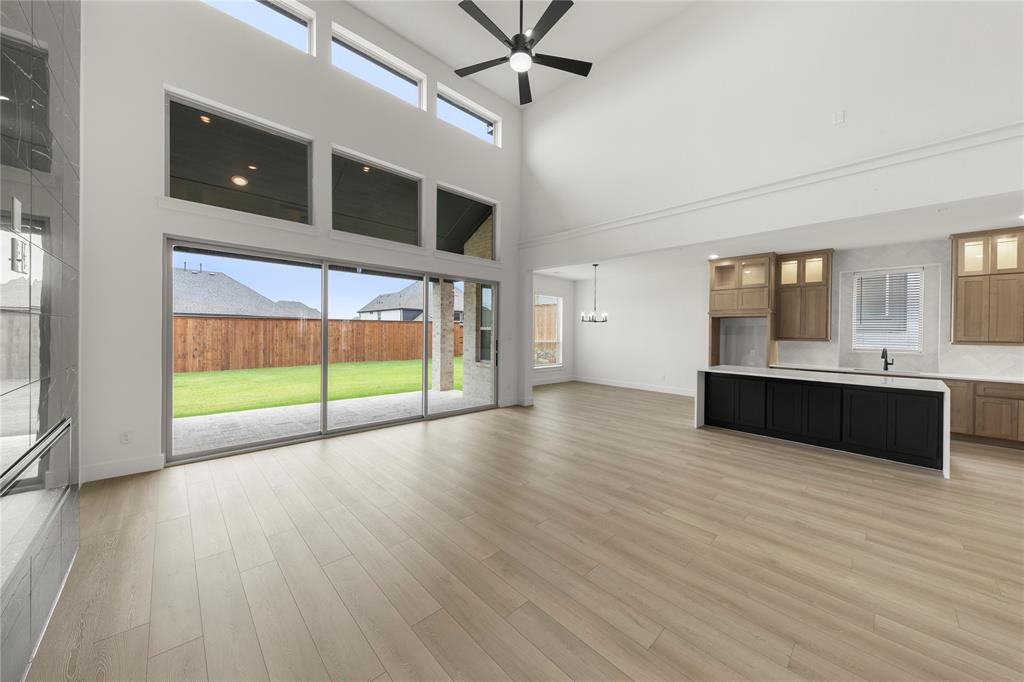 981 Georgetown Place Prosper, TX 75078 - Photo 6 of 30 a view of an empty room with window and wooden floor