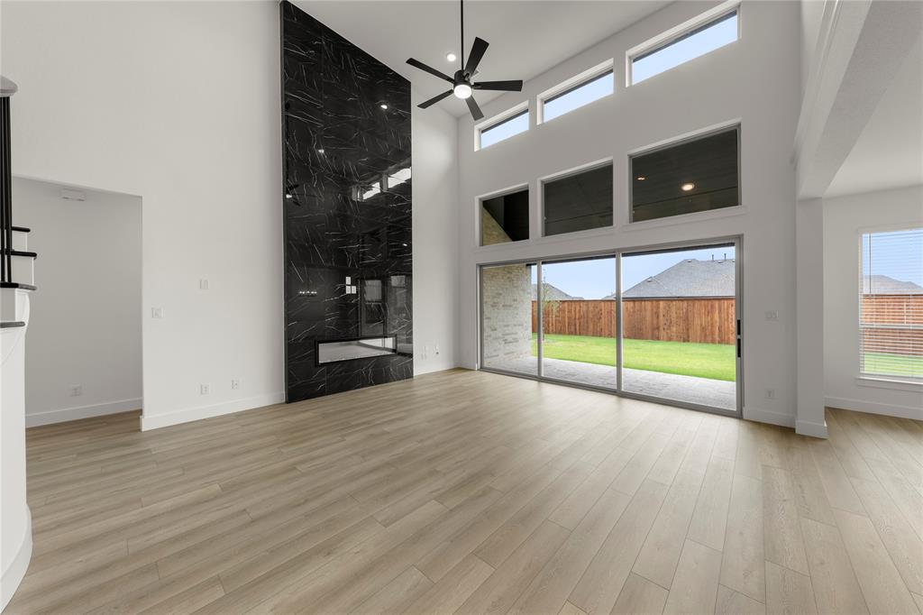981 Georgetown Place Prosper, TX 75078 - Photo 7 of 30 a view of an empty room with wooden floor and a window