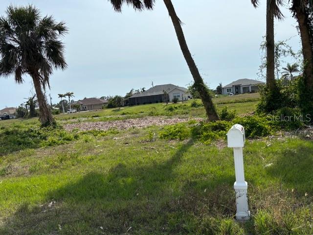 227 Tournament Road Rotonda West, FL 33947 - Photo 4 of 7 a backyard of a house with lots of green space