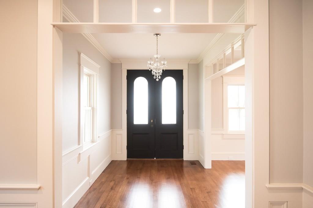a view of entryway with wooden floor and door
