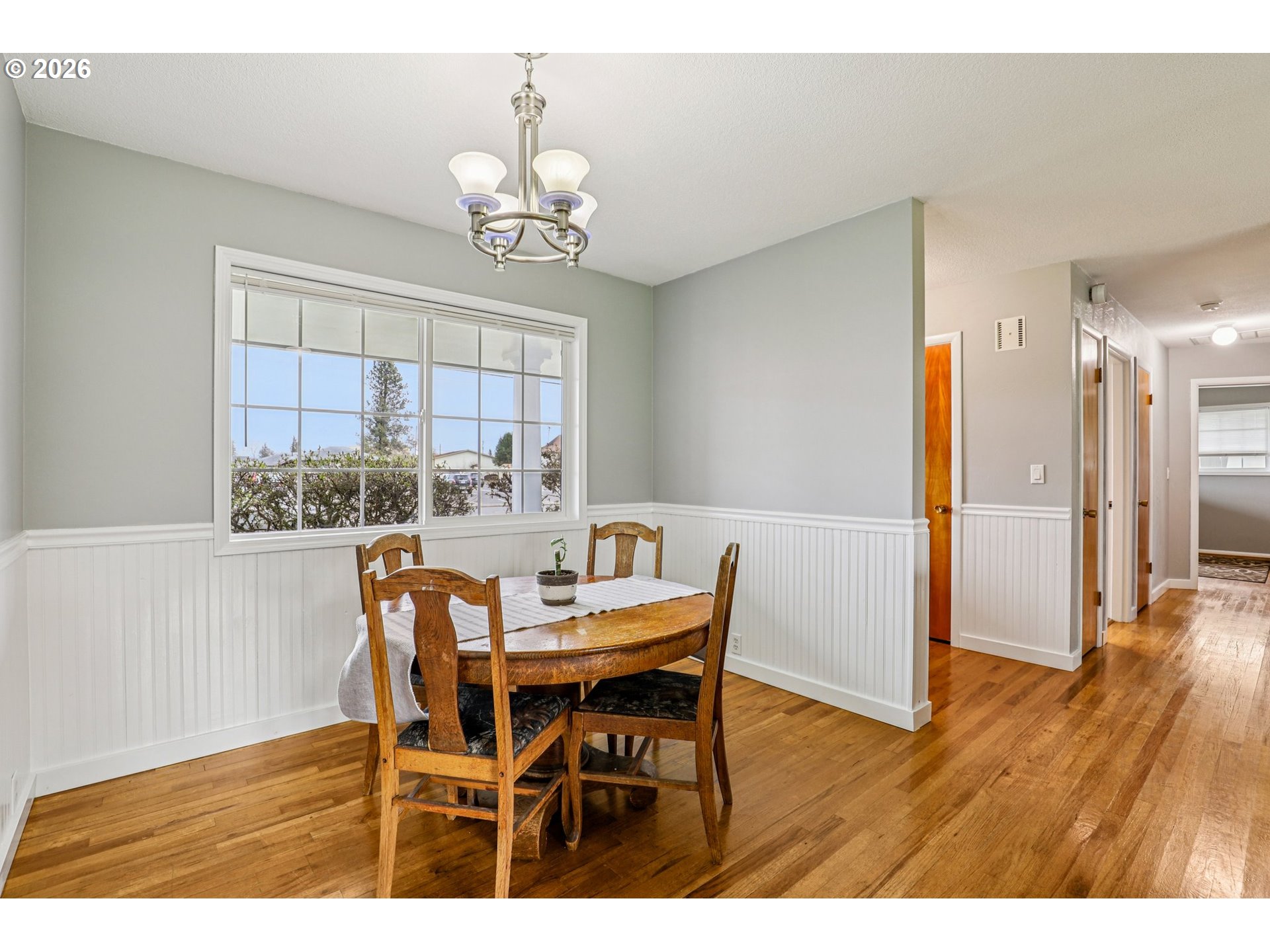 155 Sunset Boulevard St. Helens, OR 97051 - Photo 11 of 44 a view of a dining room with furniture a chandelier and wooden floor