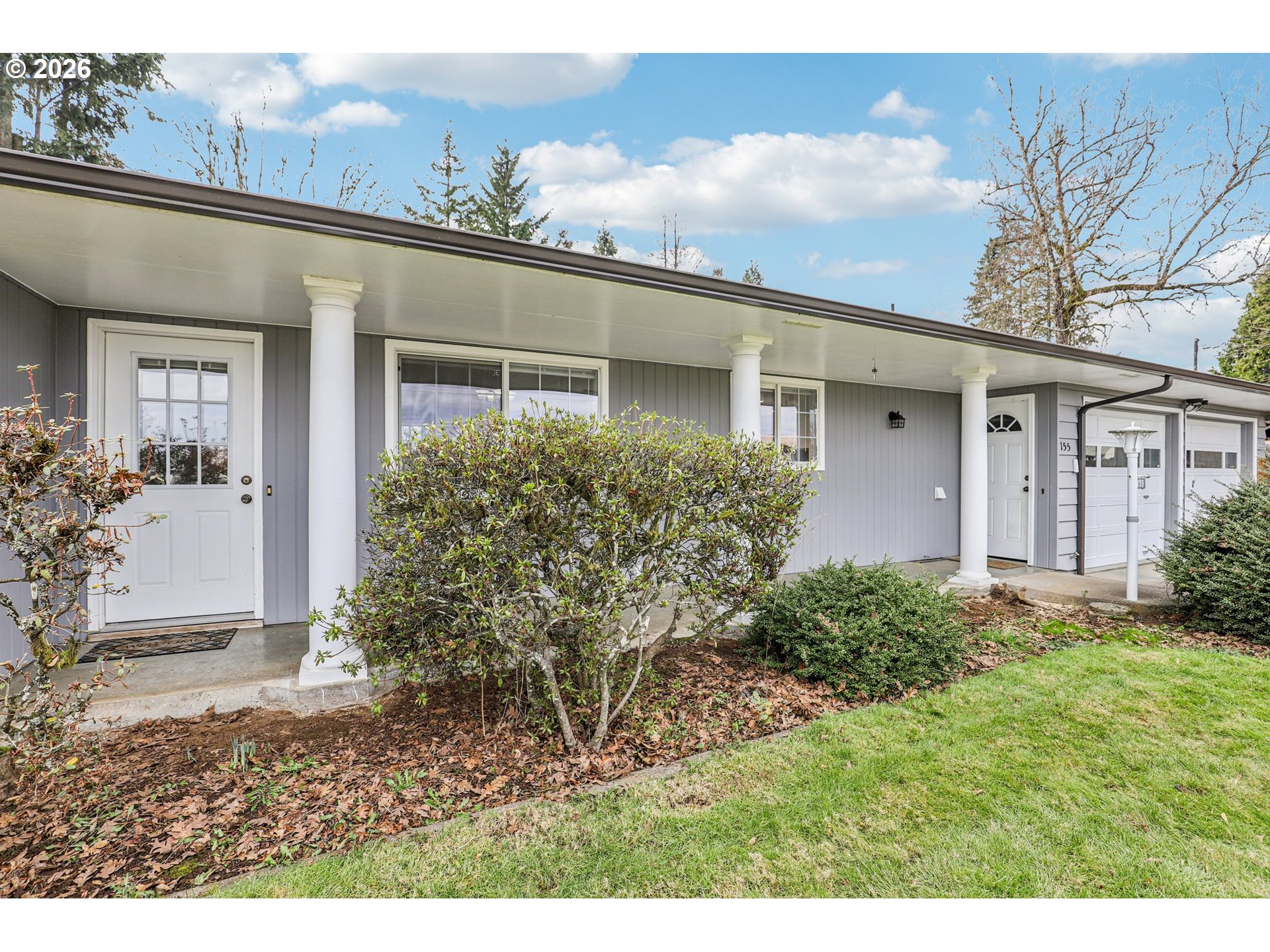 155 Sunset Boulevard St. Helens, OR 97051 - Photo 4 of 44 a view of a house with brick walls and a yard with potted plants