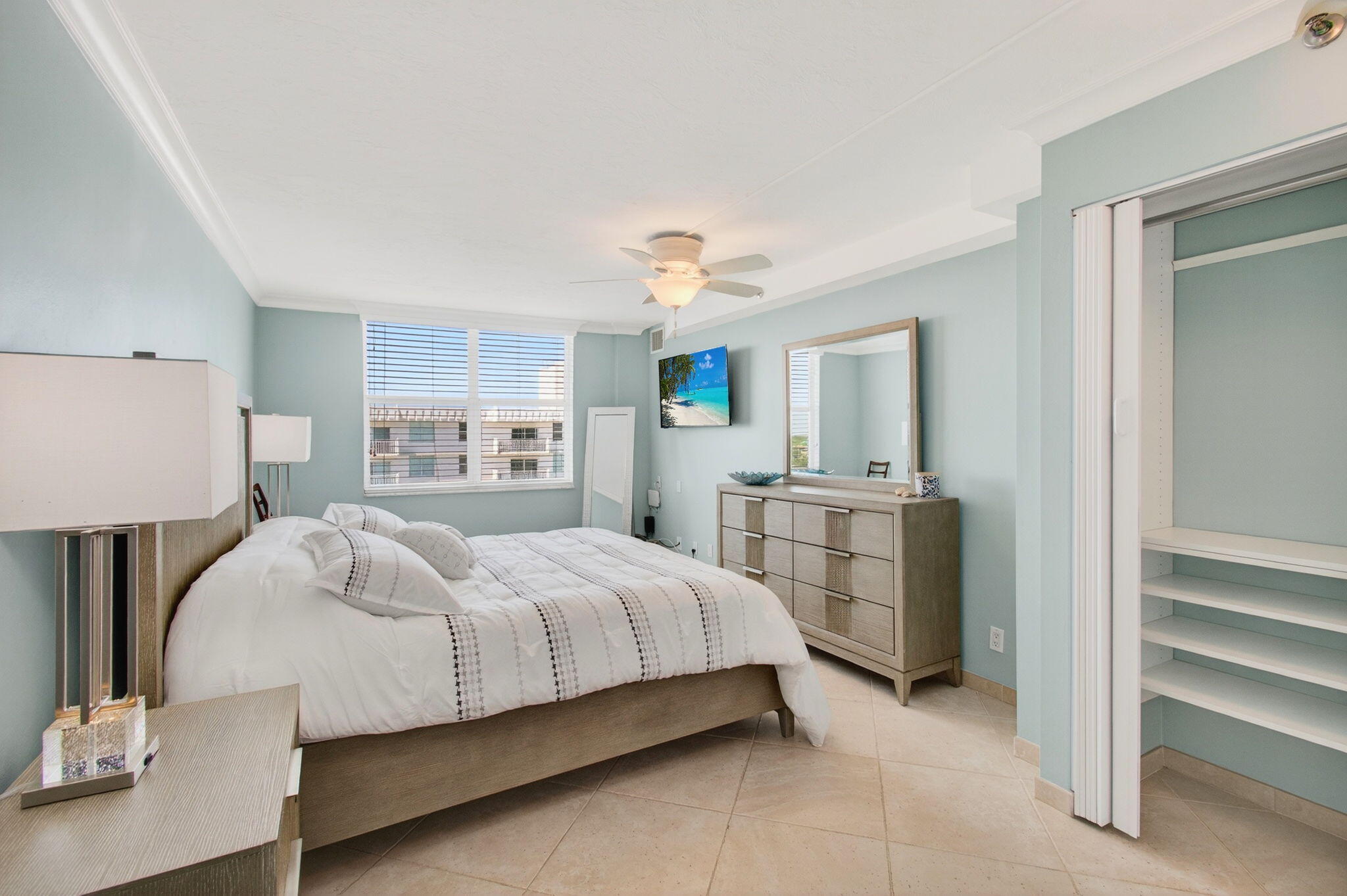 4511 South Ocean Boulevard, Unit 1004 Highland Beach, FL 33487 - Photo 15 of 76 a bedroom with a bed and a dresser