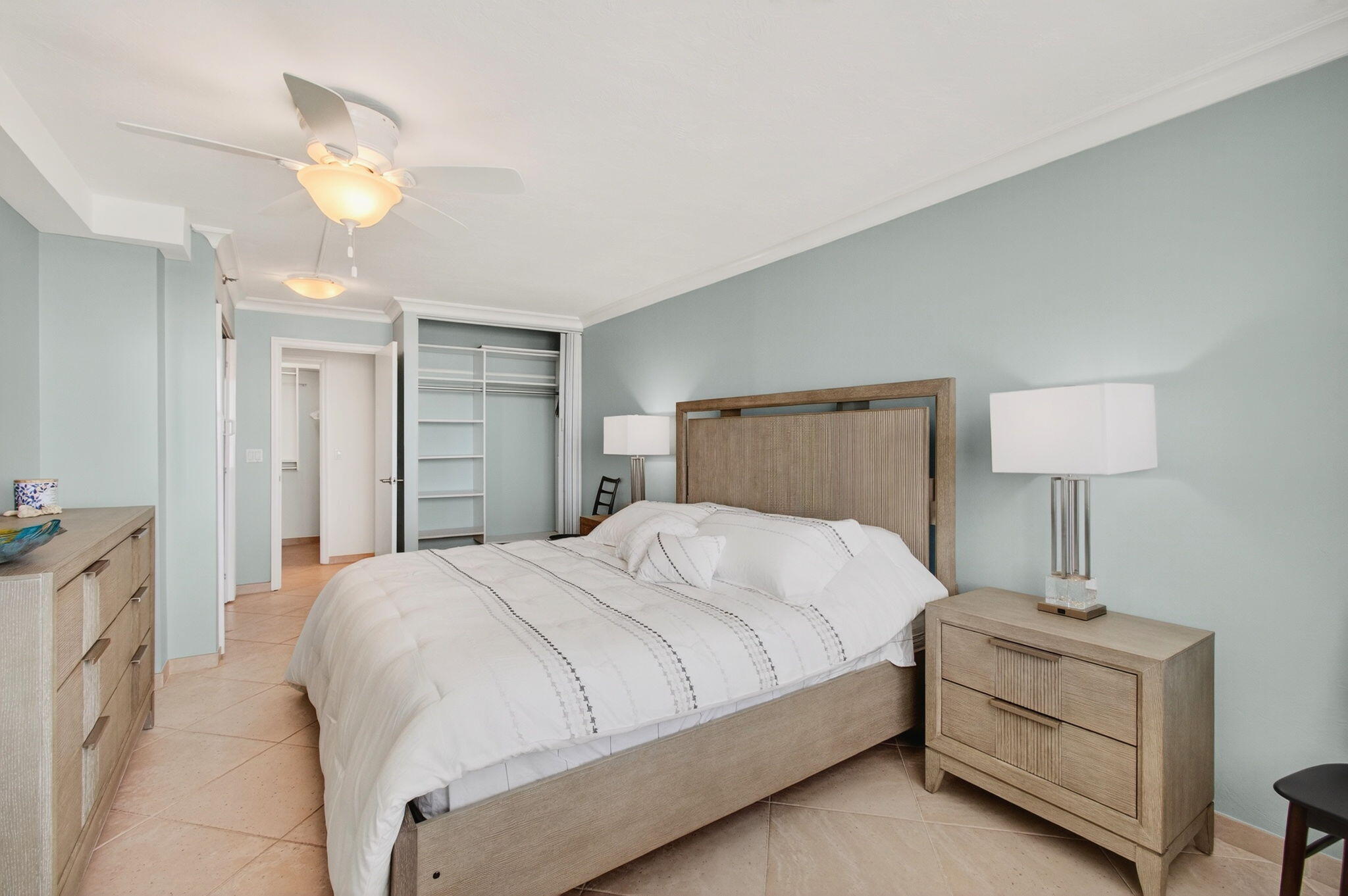4511 South Ocean Boulevard, Unit 1004 Highland Beach, FL 33487 - Photo 16 of 76 a bedroom with a bed and a chandelier