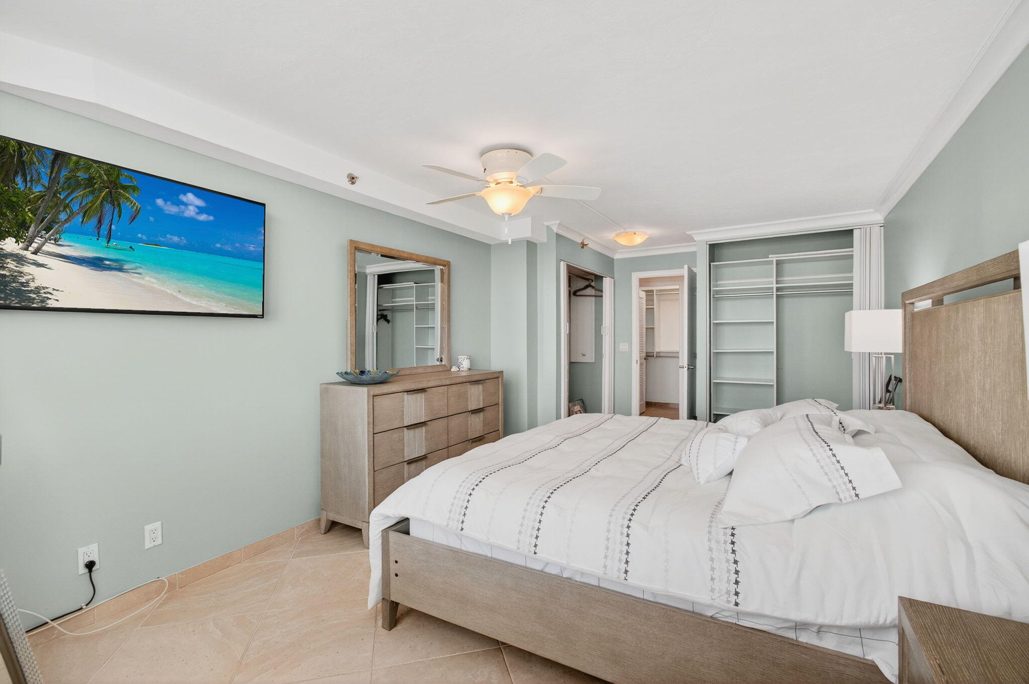4511 South Ocean Boulevard, Unit 1004 Highland Beach, FL 33487 - Photo 18 of 76 a bedroom with a bed and a chandelier