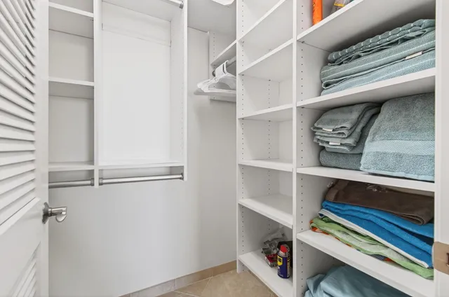 a bedroom with a bed and a table in it