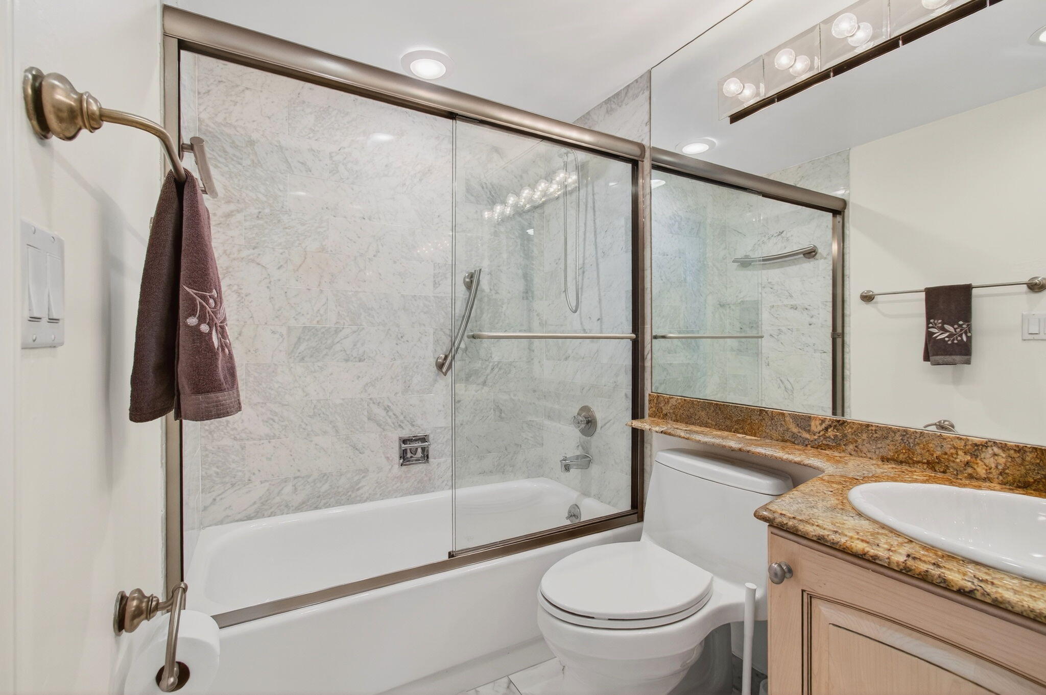 4511 South Ocean Boulevard, Unit 1004 Highland Beach, FL 33487 - Photo 23 of 76 a bathroom with a granite countertop shower sink vanity and toilet