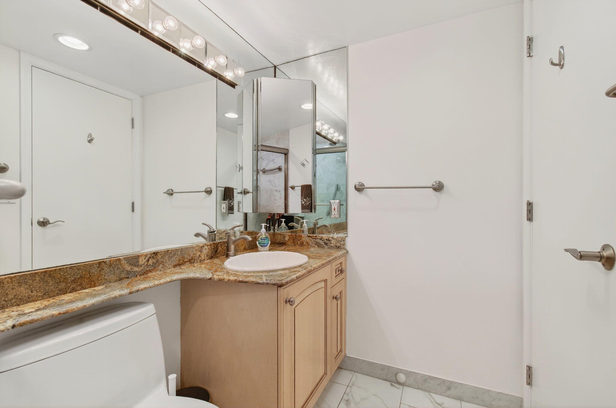 4511 South Ocean Boulevard, Unit 1004 Highland Beach, FL 33487 - Photo 24 of 76 a bathroom with a sink and a mirror