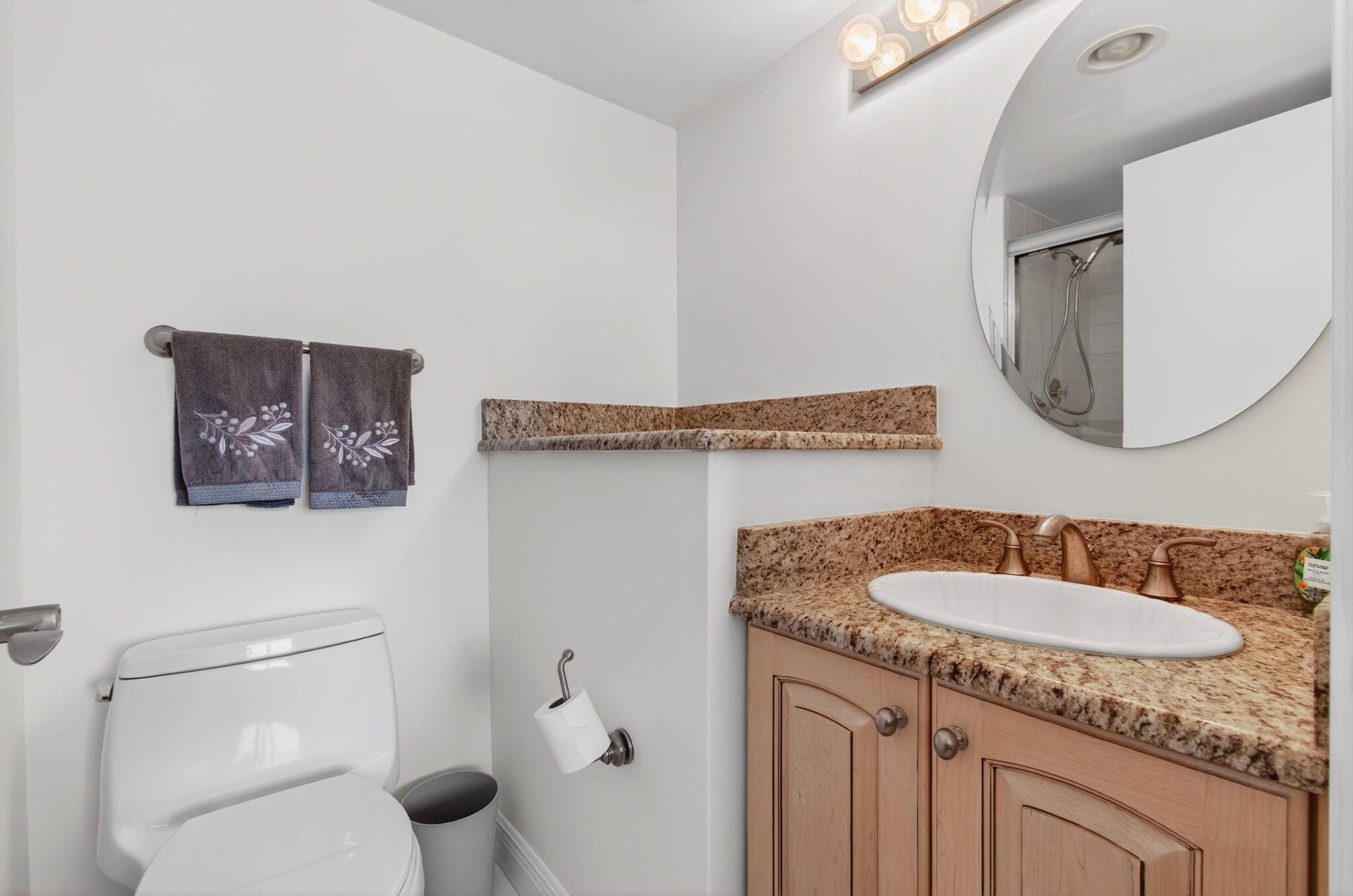 4511 South Ocean Boulevard, Unit 1004 Highland Beach, FL 33487 - Photo 31 of 76 a bathroom with a granite countertop sink and a mirror