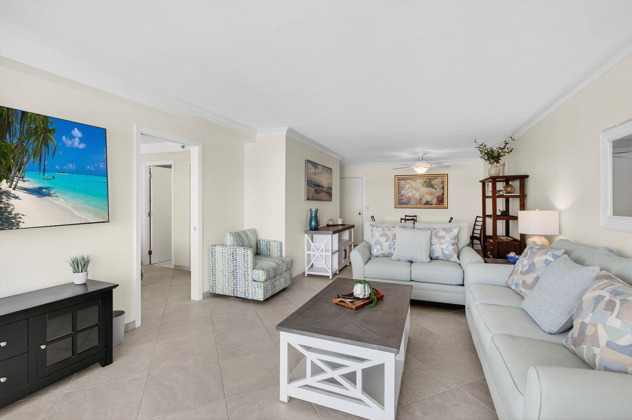 4511 South Ocean Boulevard, Unit 1004 Highland Beach, FL 33487 - Photo 4 of 76 a living room with furniture and a flat screen tv