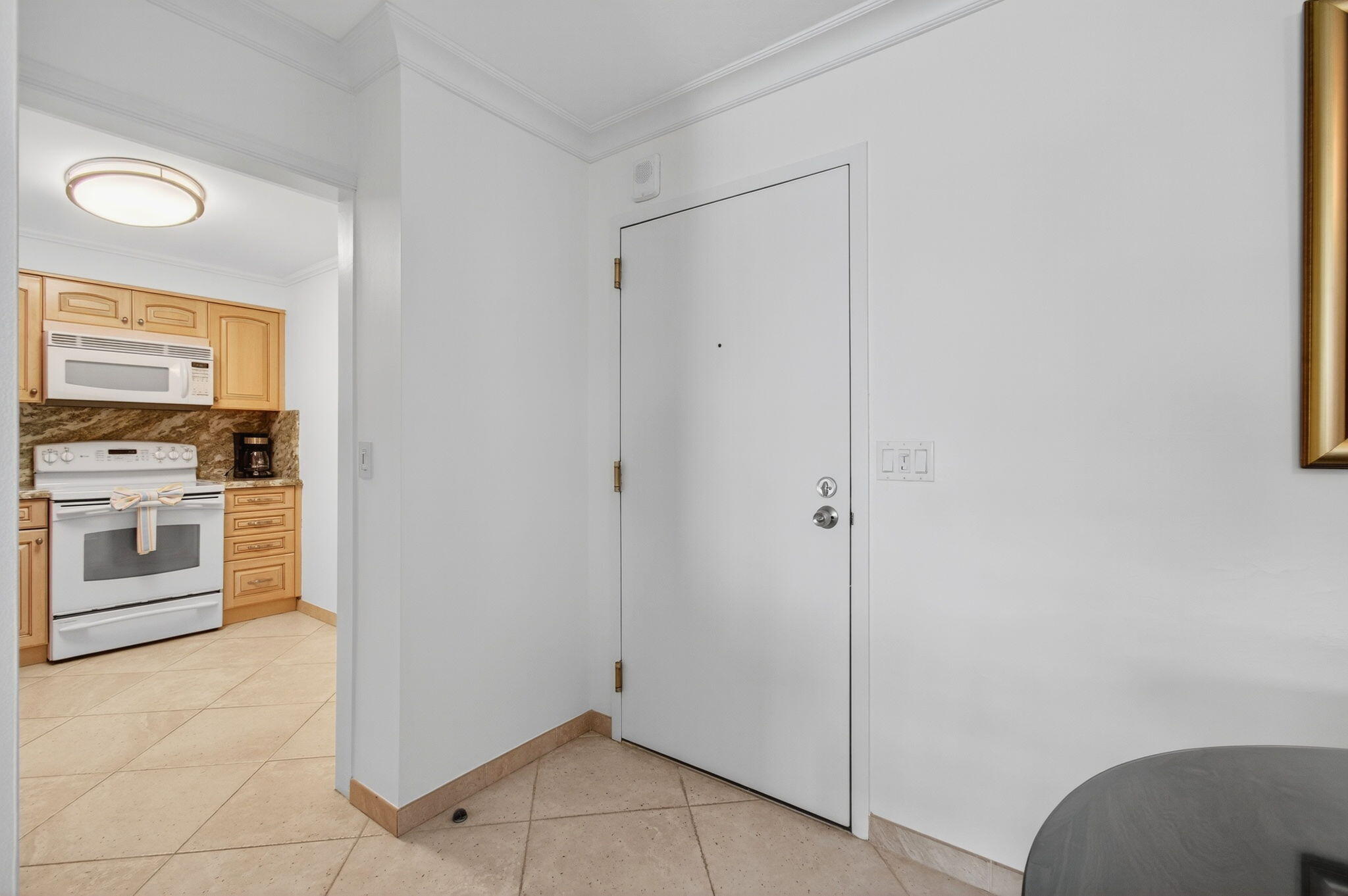 4511 South Ocean Boulevard, Unit 1004 Highland Beach, FL 33487 - Photo 43 of 76 a view of a kitchen with refrigerator and stove