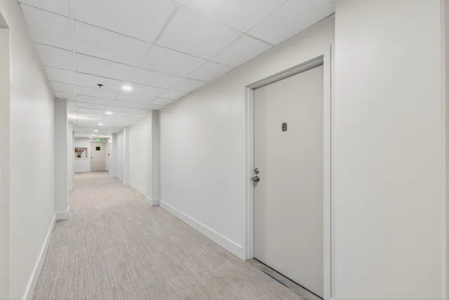a kitchen with stainless steel appliances kitchen island granite countertop a table chairs sink and cabinets