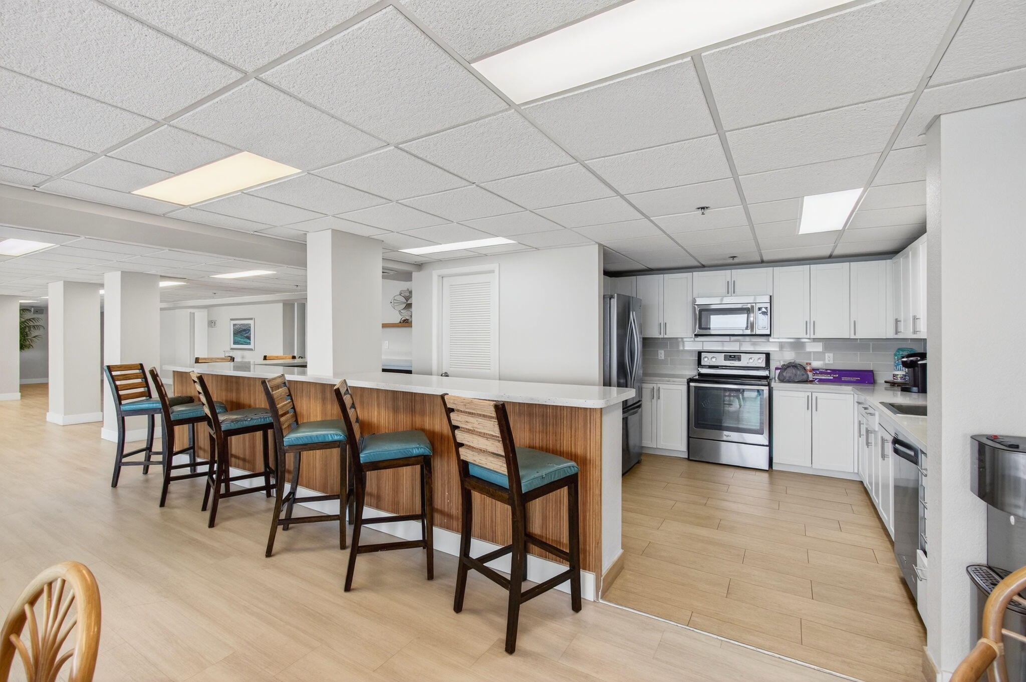 4511 South Ocean Boulevard, Unit 1004 Highland Beach, FL 33487 - Photo 59 of 76 a kitchen with stainless steel appliances kitchen island granite countertop a table chairs sink and cabinets
