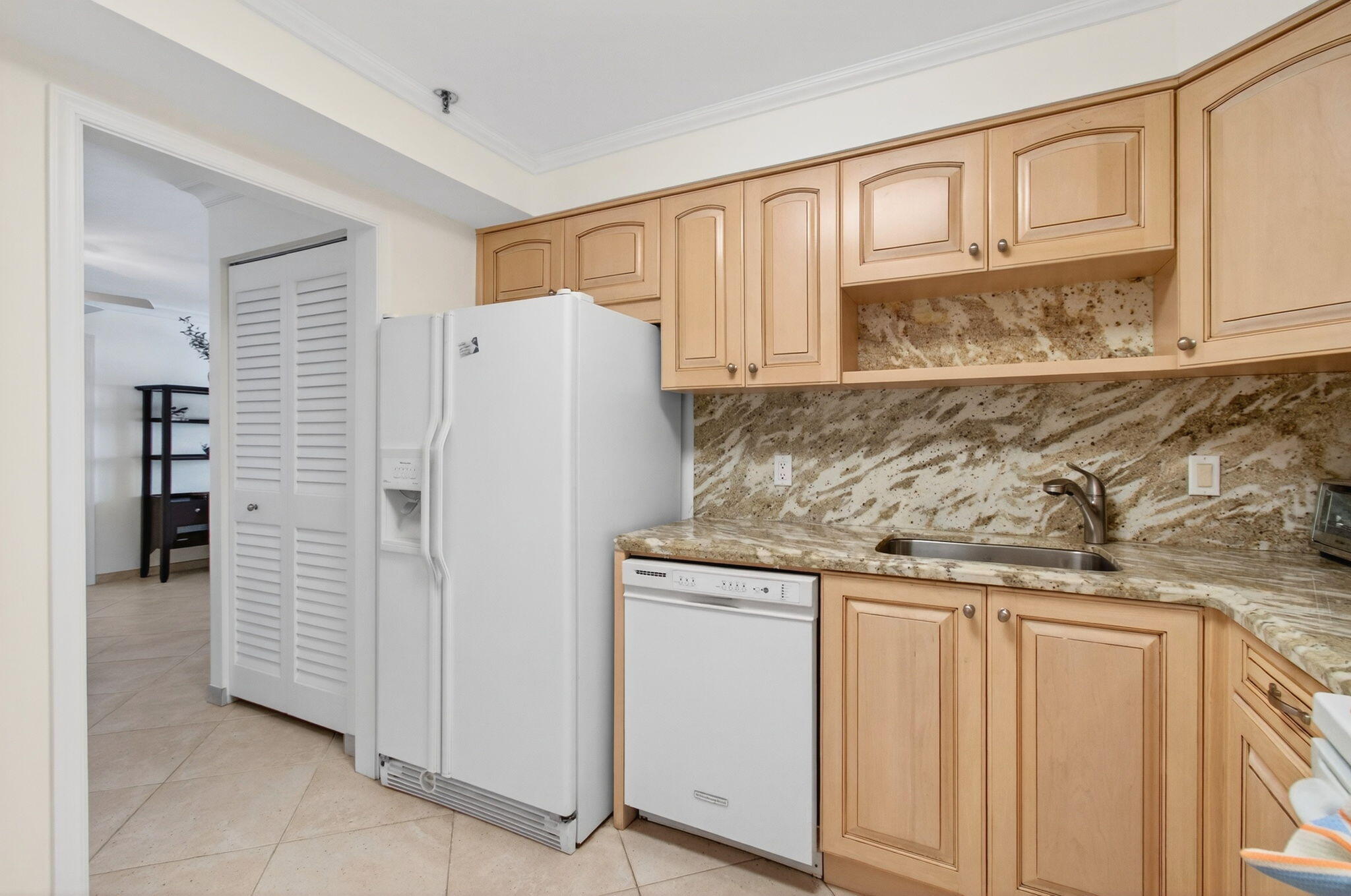 4511 South Ocean Boulevard, Unit 1004 Highland Beach, FL 33487 - Photo 10 of 76 a kitchen with stainless steel appliances granite countertop a refrigerator and a stove