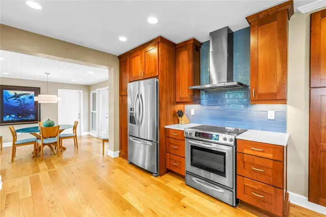 a large kitchen with a sink cabinets and wooden floor