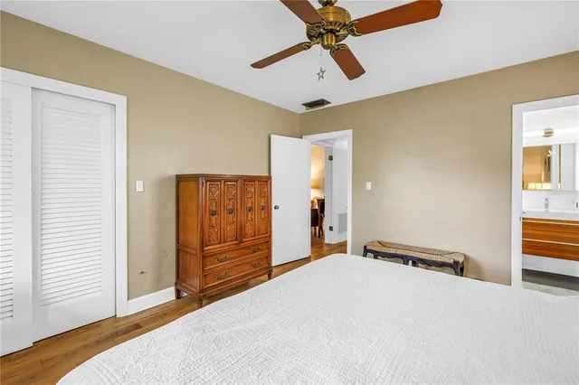 a bedroom with a bed a table and chair