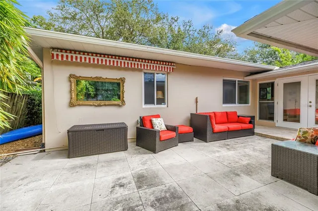 a view of backyard with plants and chairs