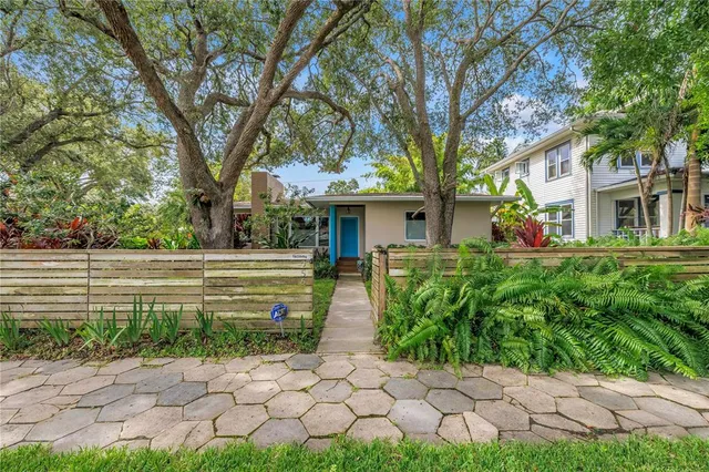 a front view of a house with a garden