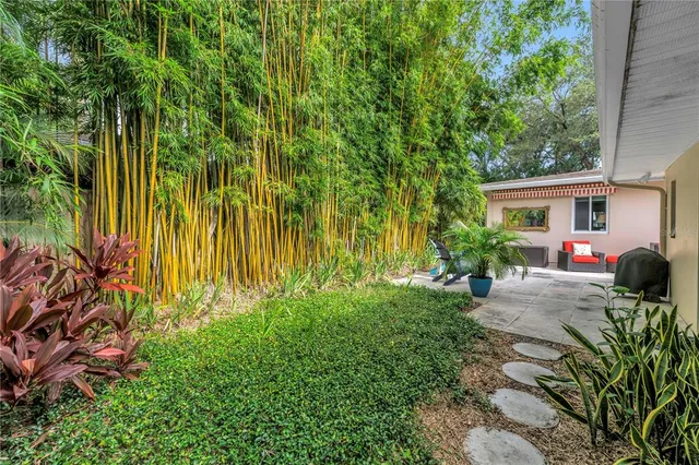 a wooden bench sitting in a backyard next to a lake