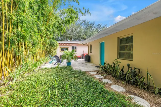 a view of a house with a yard and plants