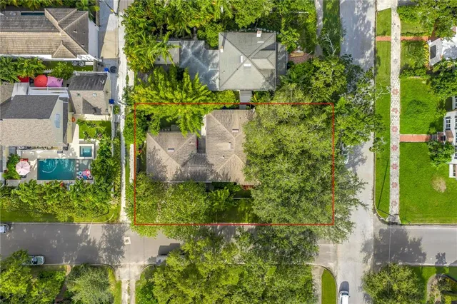 an aerial view of a house with a yard