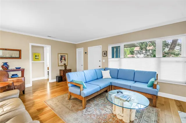 a living room with furniture wooden floor and a table