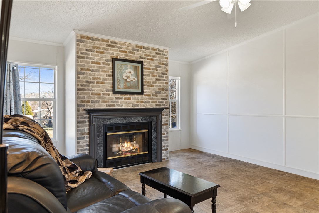811 Pine Grove Road Seneca, SC 29678 - Photo 3 of 20 This inviting living room offers warmth and comfort with a charming brick fireplace.