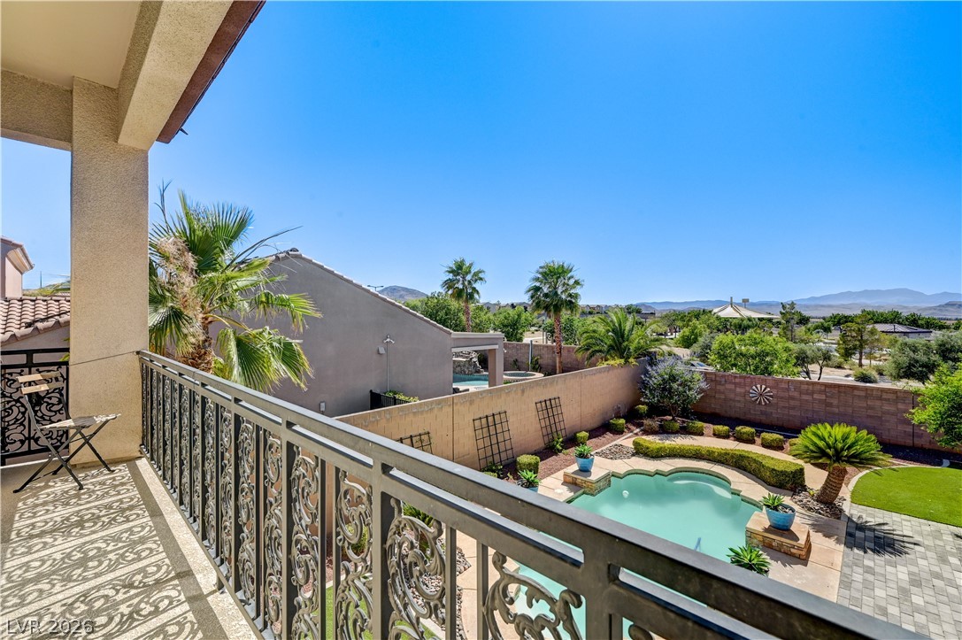 2793 Rosenhearty Drive Henderson, NV 89044 - Photo 60 of 85 This elevated view captures a serene backyard oasis featuring a shaped pool and lush greenery, all under an open sky.