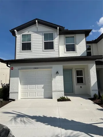 a white building with a window and balcony