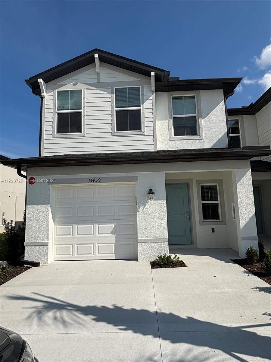17459 Monte Isola Way Fort Myers, FL 33917 - Photo 1 of 24 a white building with a window and balcony