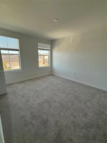 a view of a room with a wooden floor and white walls