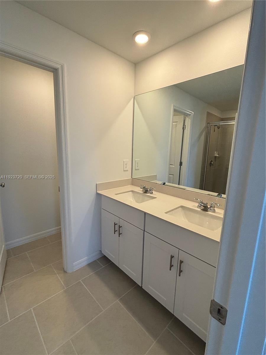 17459 Monte Isola Way Fort Myers, FL 33917 - Photo 20 of 24 a bathroom with a double vanity sink a mirror and a