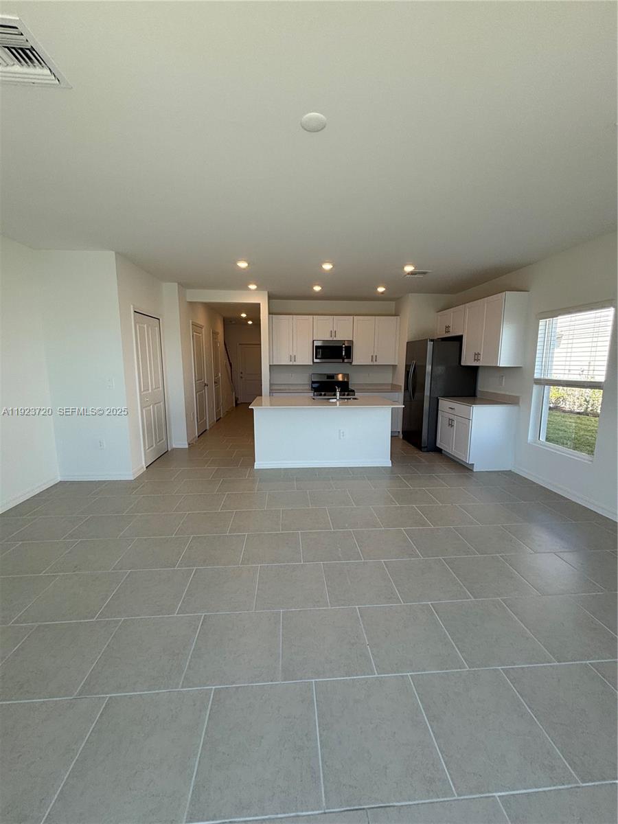17459 Monte Isola Way Fort Myers, FL 33917 - Photo 7 of 24 a view of a livingroom with furniture and a ceiling fan