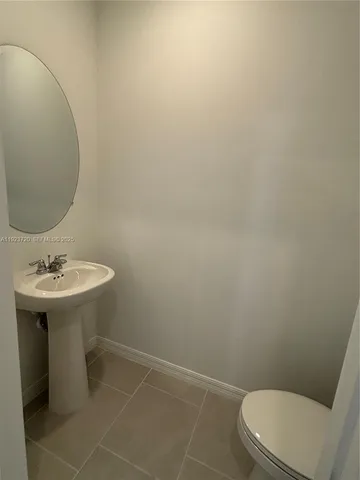 a bathroom with a sink toilet and a mirror