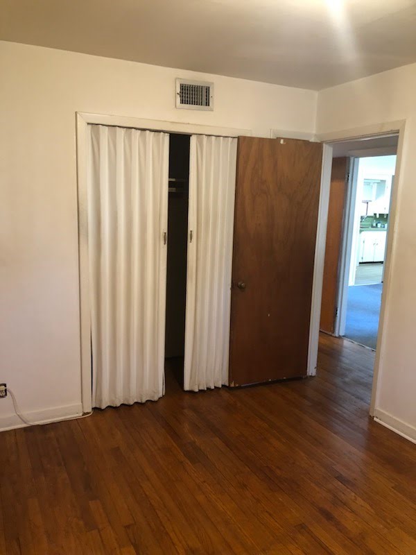 6841 Concho Street Houston, TX 77074 - Photo 5 of 17 an empty room with wooden floor and windows