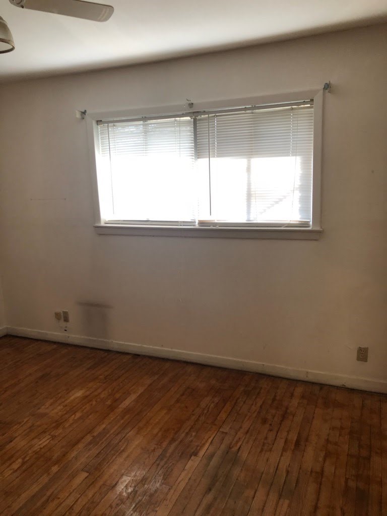 6841 Concho Street Houston, TX 77074 - Photo 9 of 17 an empty room with wooden floor and windows