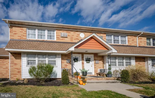 a front view of a house with garden and porch