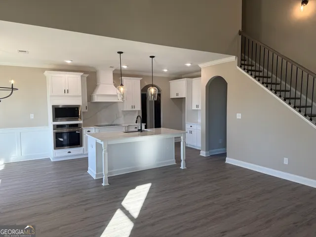 a view of kitchen with sink microwave and stove
