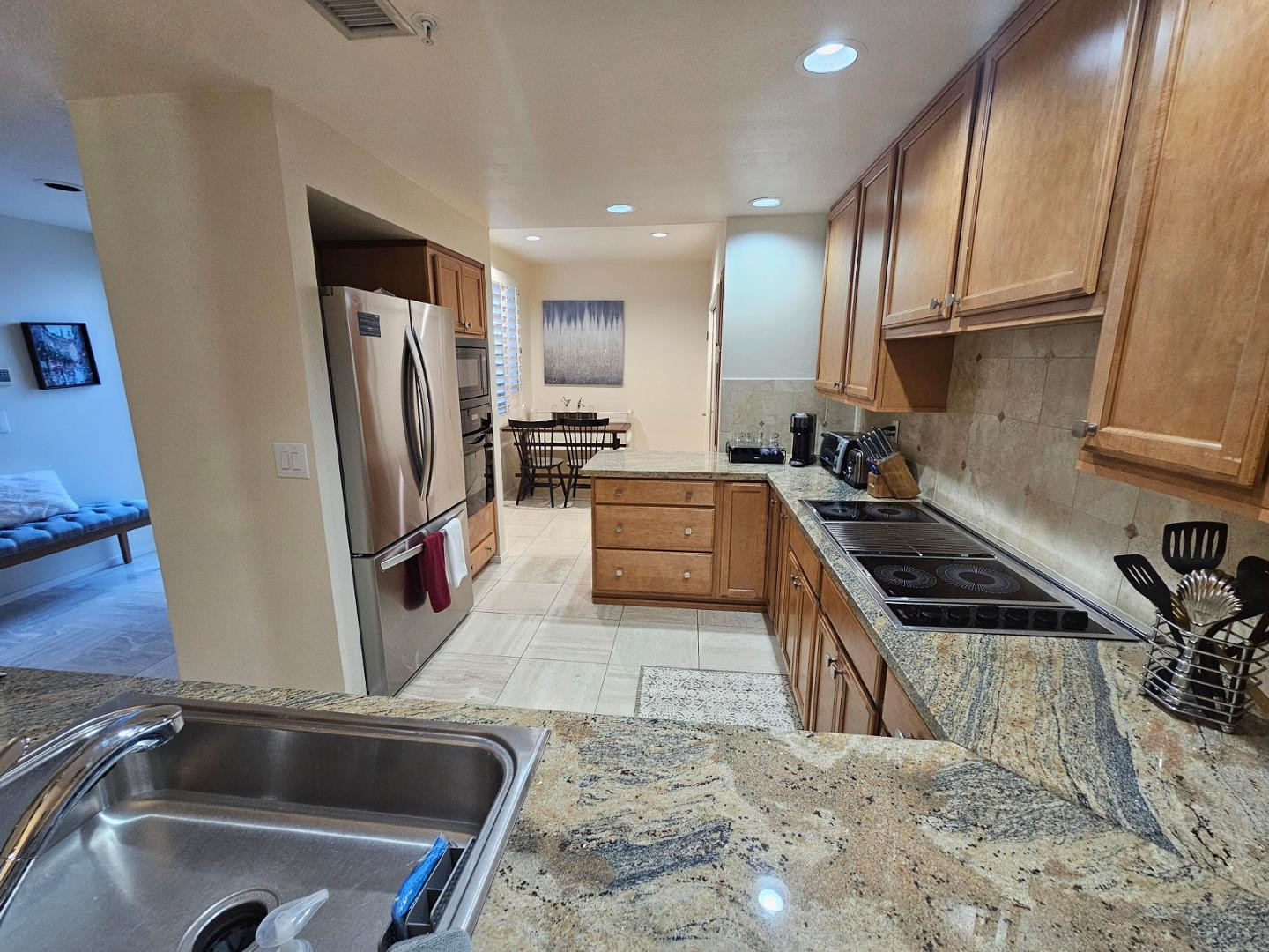 7700 East Gainey Ranch Road, Unit 153 Scottsdale, AZ 85258 - Photo 3 of 24 a kitchen with granite countertop a sink stainless steel appliances and cabinets