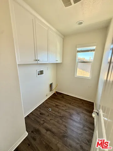 a view of an empty room and wooden floor