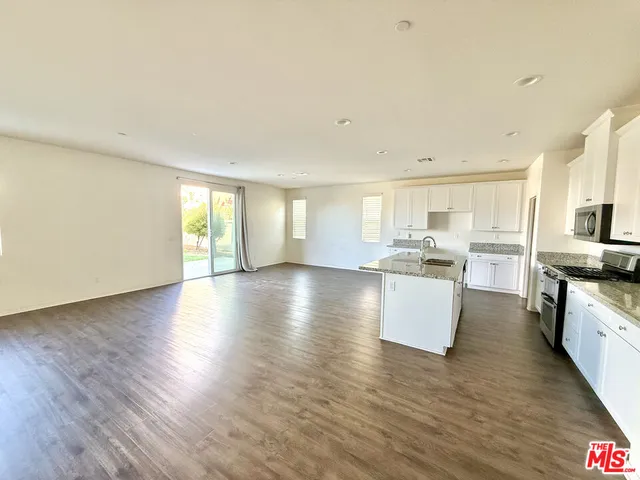 a view of kitchen with furniture and wooden floor