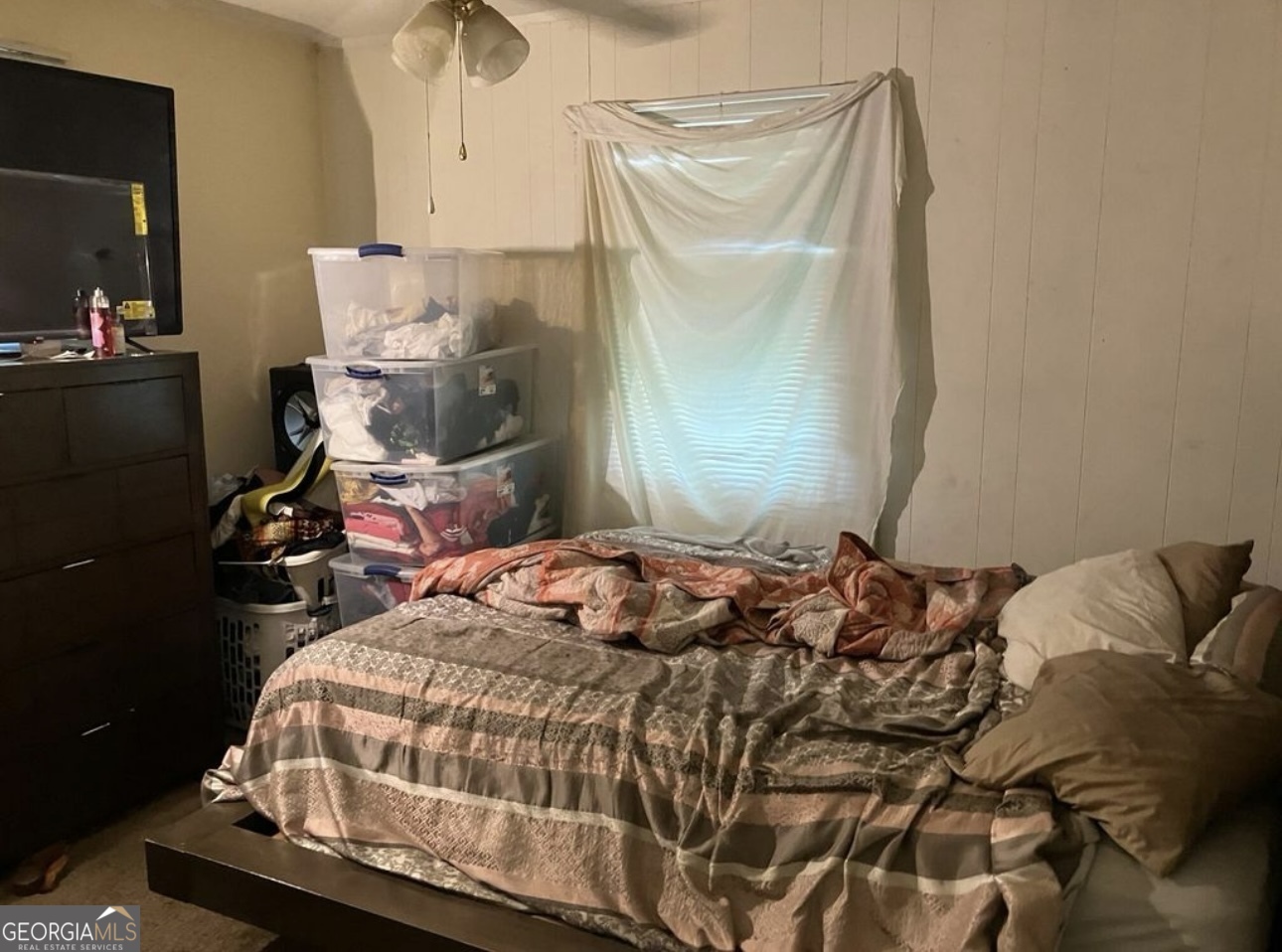 212 Whitehead Street Thomson, GA 30824 - Photo 6 of 9 a bedroom with a bed and wooden floor