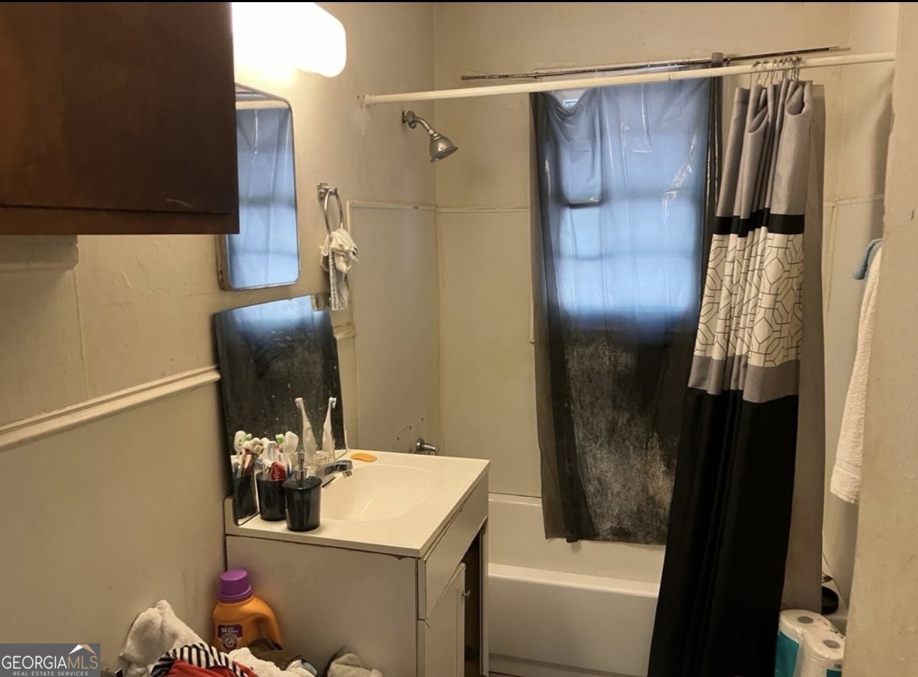 212 Whitehead Street Thomson, GA 30824 - Photo 7 of 9 a bathroom with a sink and mirror