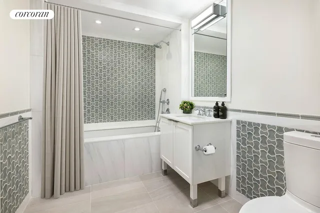 a bedroom with two beds and a chandelier