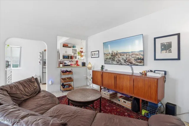 a living room with furniture a couch and a wall painting