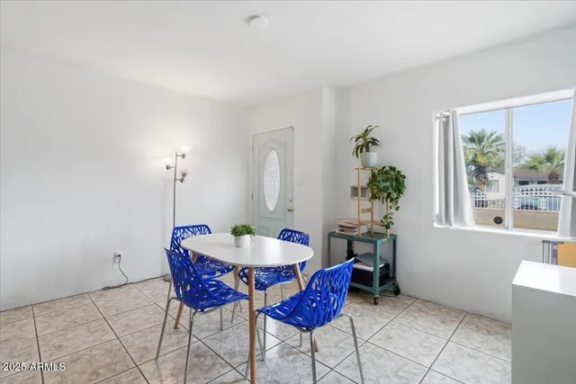 a view of a dining area with furniture and a large window