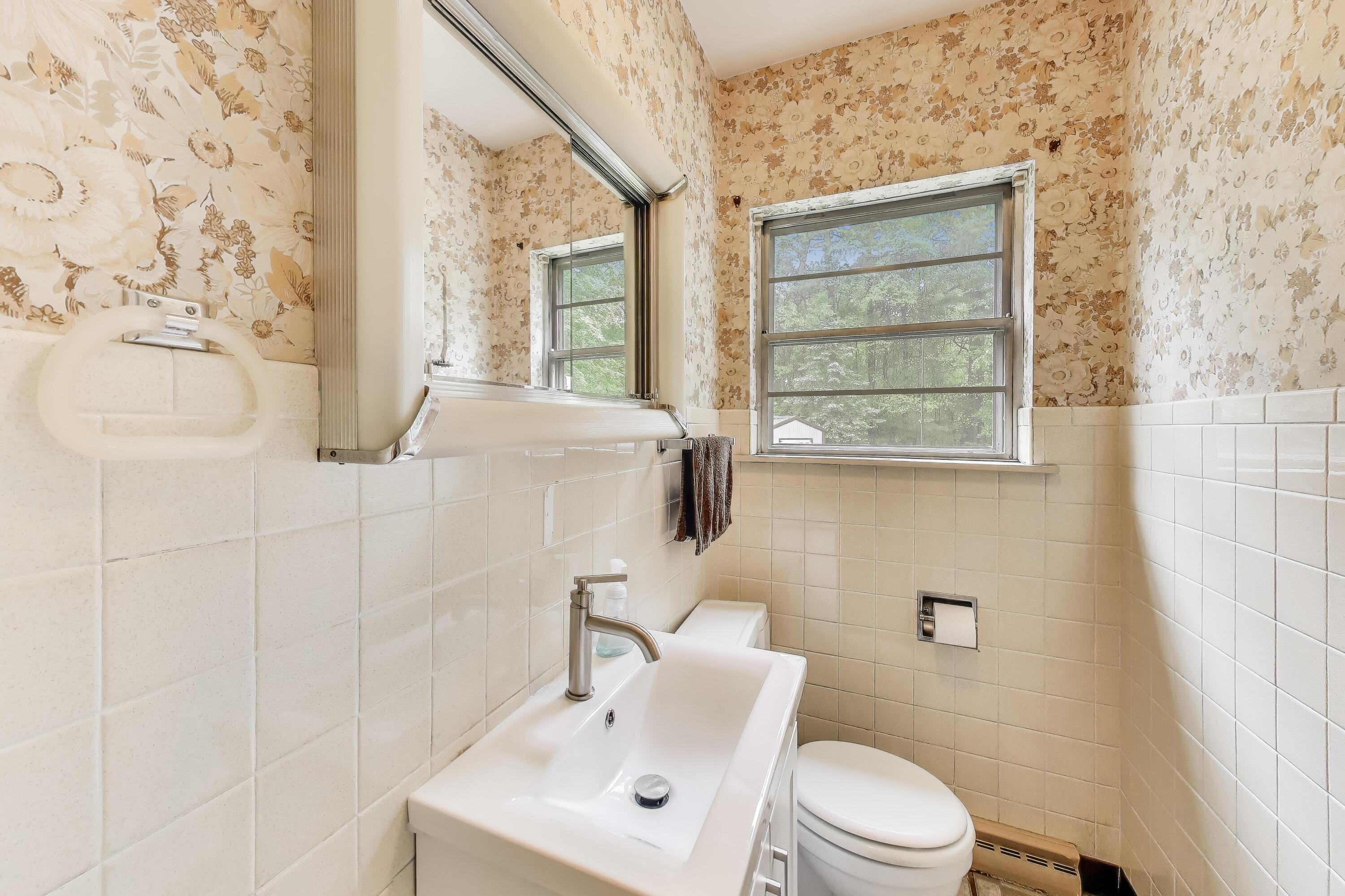451 Johnson Road Trail Creek, IN 46360 - Photo 25 of 55 a bathroom with a toilet sink and mirror